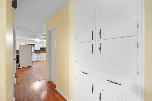 a view of a hallway with wooden floor