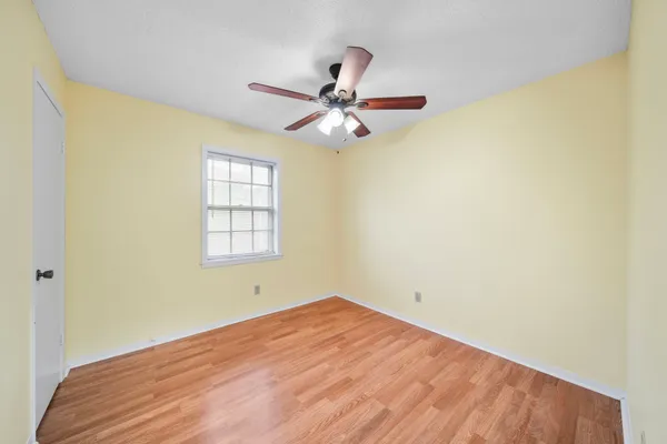a view of a room with a window and ceiling fan