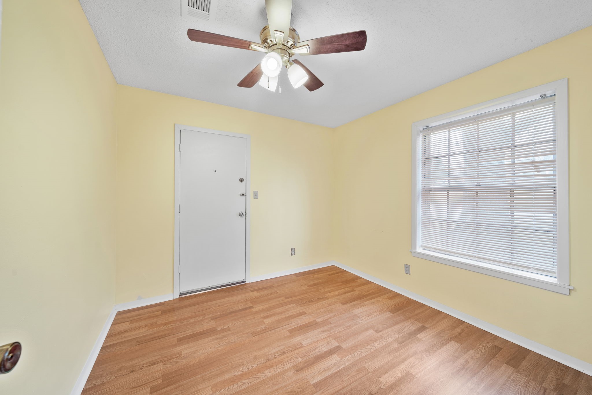 2217 Old Chappell Hill Road Brenham, TX 77833 - Photo 18 of 28 an empty room with windows and fan