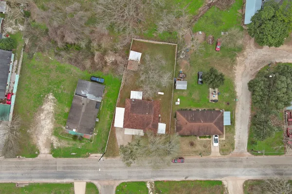 an aerial view of a house with a yard