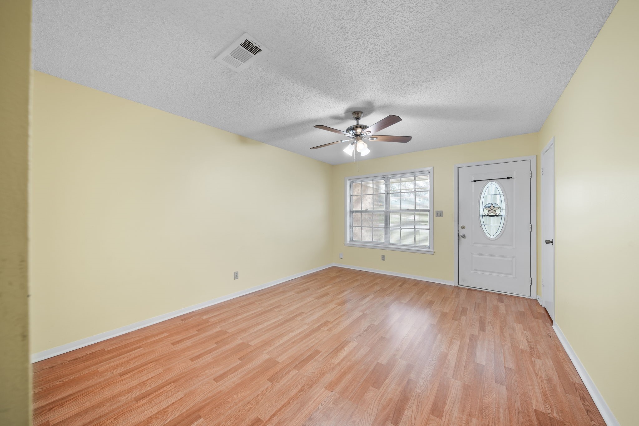 2217 Old Chappell Hill Road Brenham, TX 77833 - Photo 5 of 28 a view of an empty room with wooden floor and a window