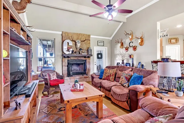 a living room with furniture a fireplace and a flat screen tv