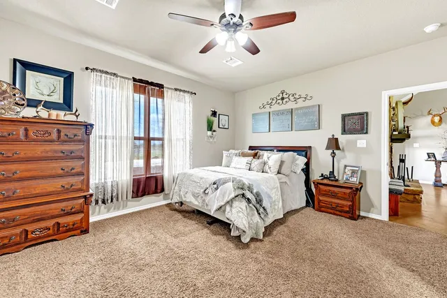 a spacious bedroom with a bed and furniture