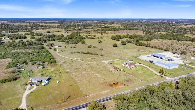 an aerial view of a tennis ground and a building