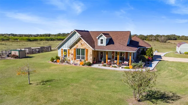 a view of a house with swimming pool and sitting area