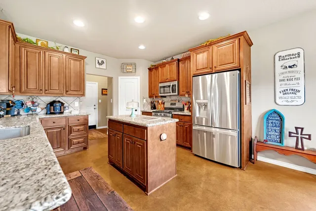 a kitchen with refrigerator cabinets and wooden floor