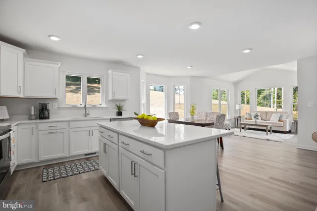 a kitchen with a sink window and cabinets