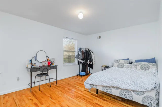 a bedroom with a bed and a desk