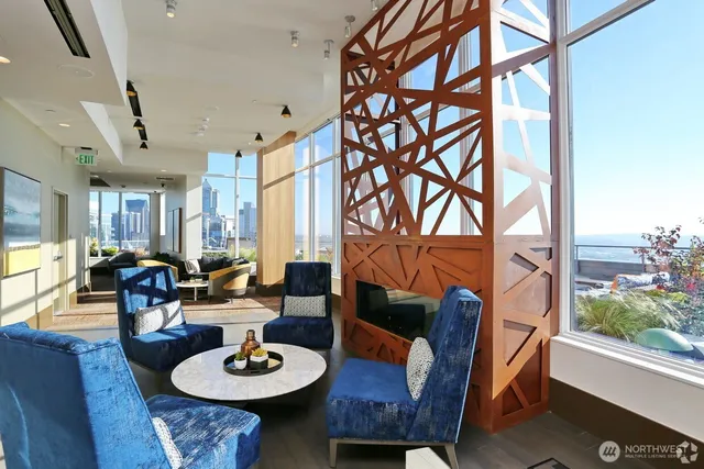a living room with furniture and a floor to ceiling window