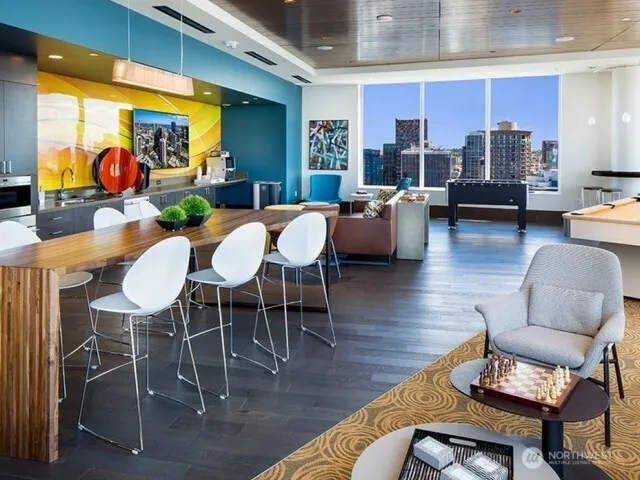 a living room with fireplace furniture and a large window
