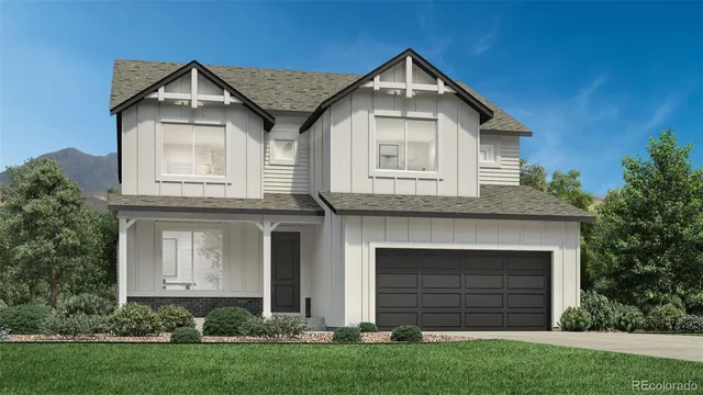 a front view of a house with a garden and garage