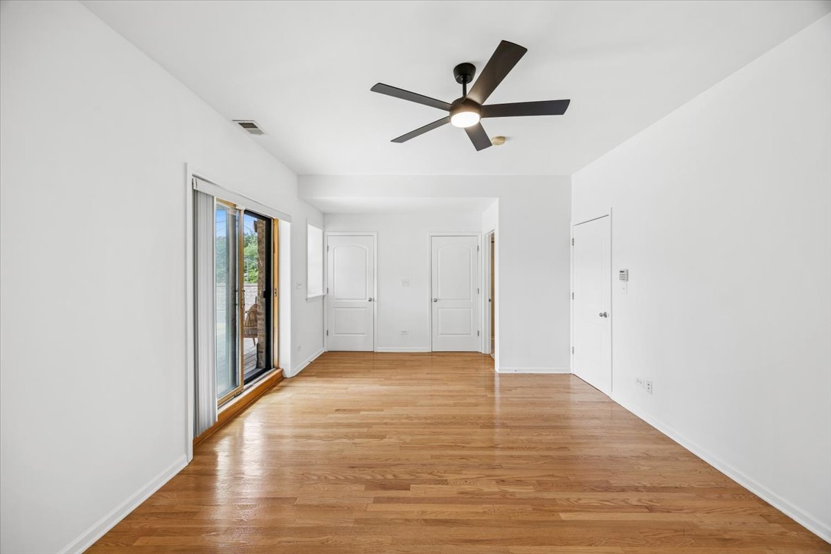 2363 East 70th Street, Unit 1 Chicago, IL 60649 - Photo 19 of 26 a view of a big room with wooden floor and windows in a room