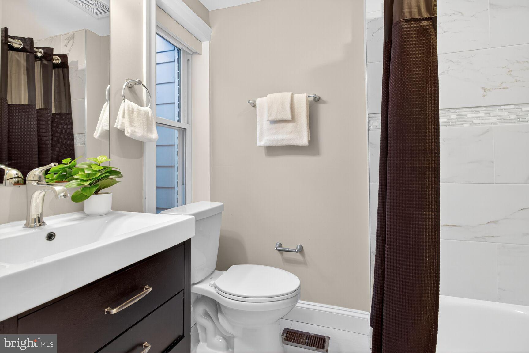 1473 Reynolds Street Baltimore, MD 21230 - Photo 13 of 43 a bathroom with a sink toilet and shower