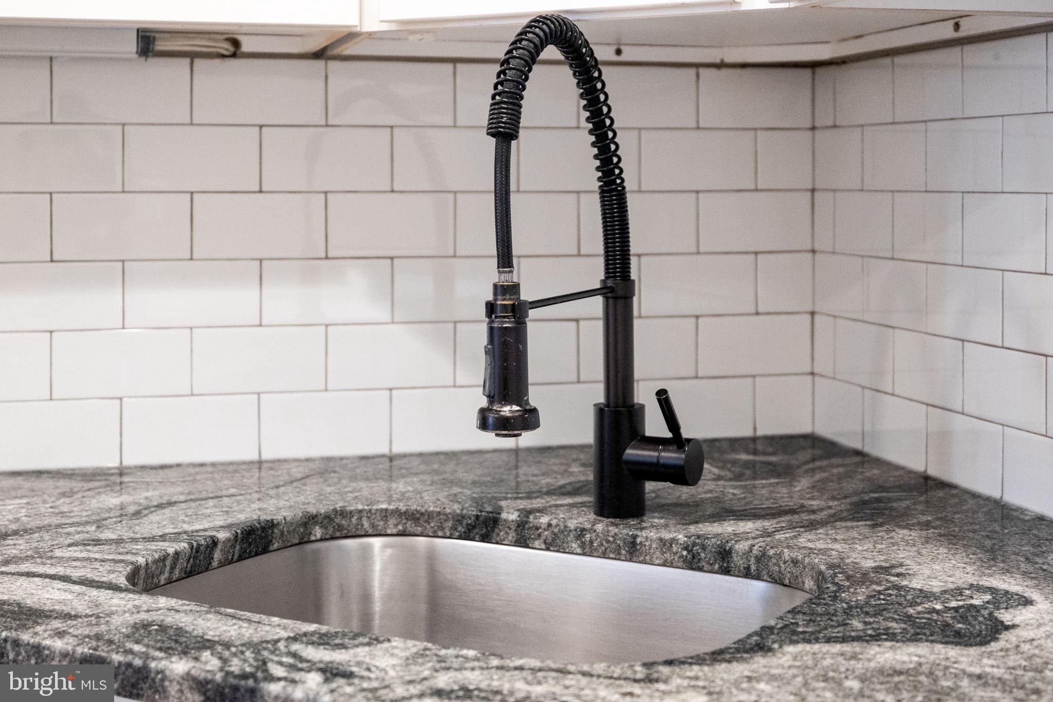 1473 Reynolds Street Baltimore, MD 21230 - Photo 21 of 43 a bathroom with a granite countertop sink