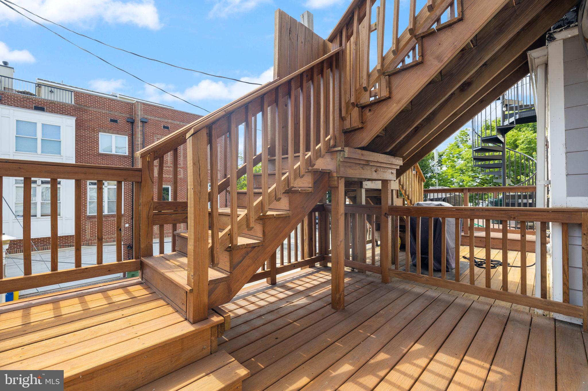 1473 Reynolds Street Baltimore, MD 21230 - Photo 24 of 43 a view of front door deck with wooden floor and fence