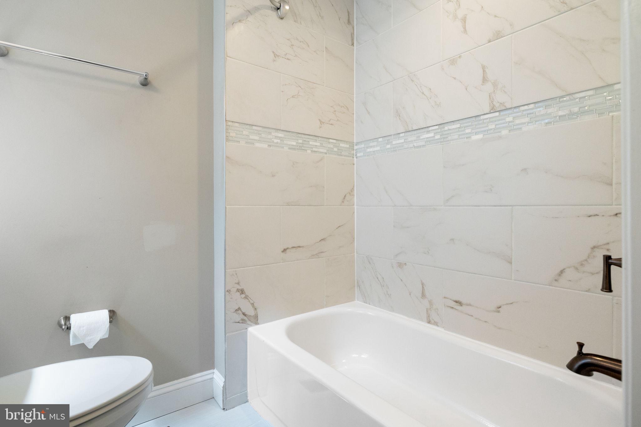 1473 Reynolds Street Baltimore, MD 21230 - Photo 28 of 43 a bathroom with a bathtub and a shower