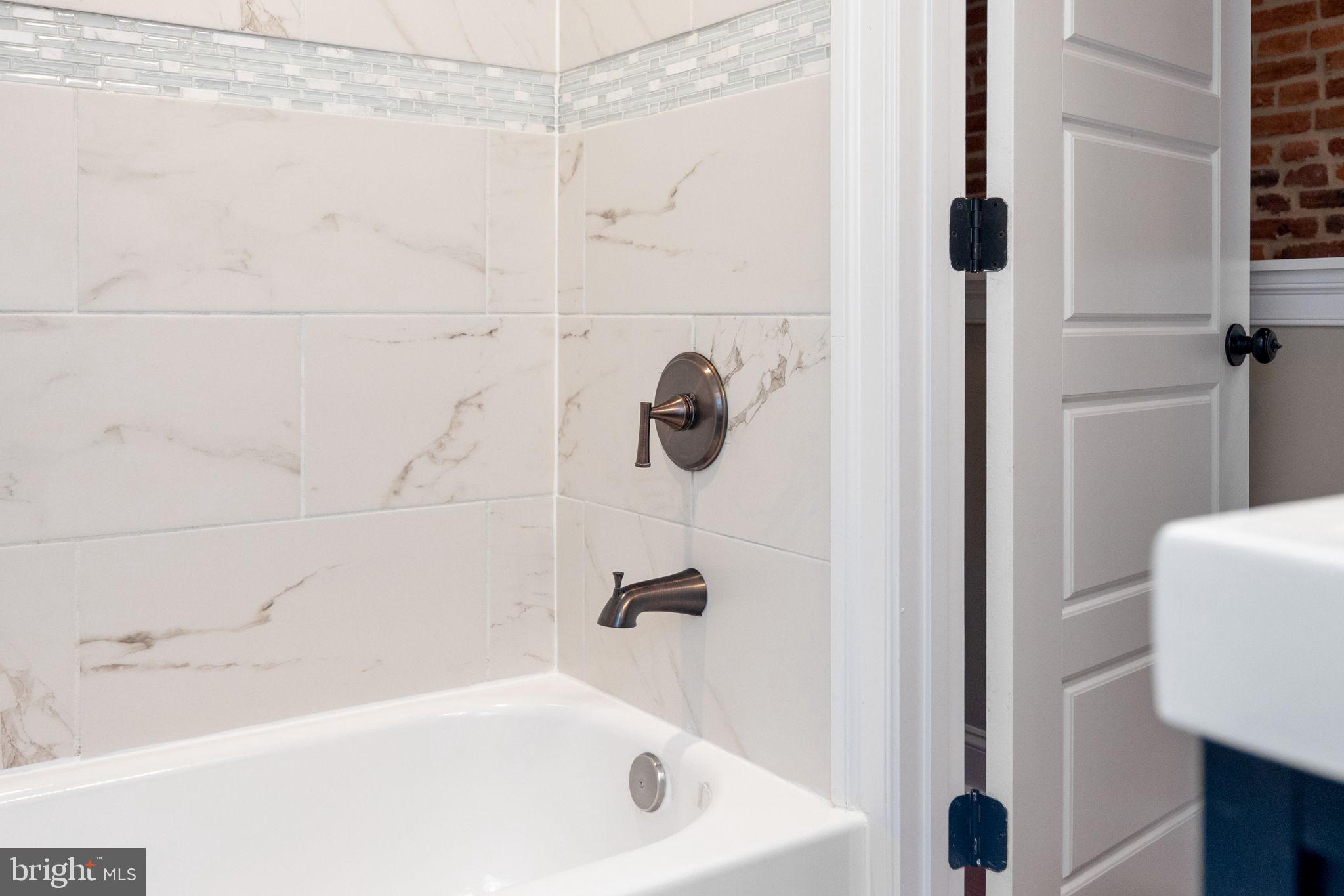 1473 Reynolds Street Baltimore, MD 21230 - Photo 30 of 43 a bathroom with a tub