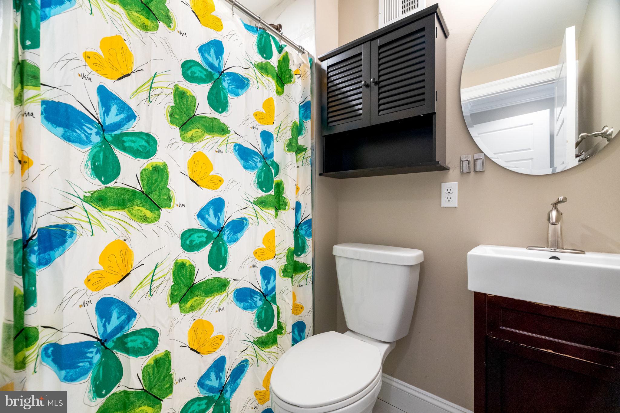 1473 Reynolds Street Baltimore, MD 21230 - Photo 32 of 43 a bathroom with a sink toilet and mirror