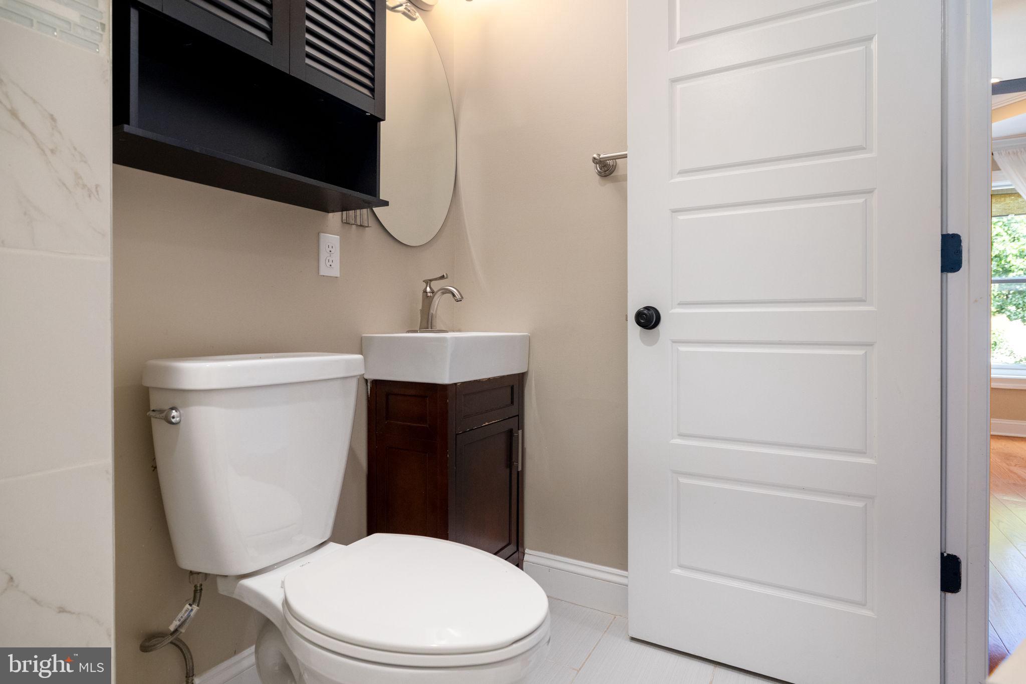 1473 Reynolds Street Baltimore, MD 21230 - Photo 33 of 43 a white toilet sitting next to a bathroom sink