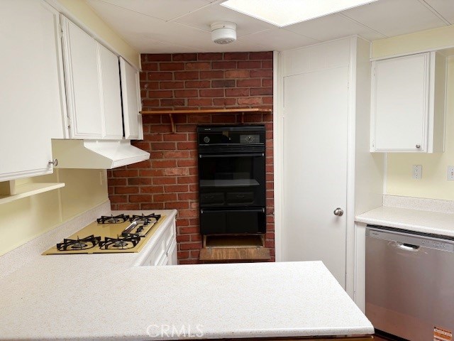 14851 Jeffrey Road, Unit 326 Irvine, CA 92618 - Photo 3 of 13 a kitchen with a stove and white cabinets