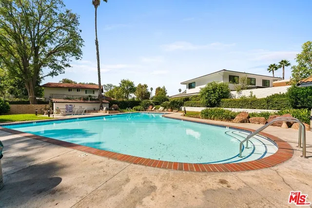 a view of a swimming pool with a yard