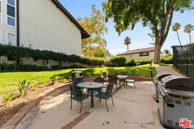 a view of swimming pool with outdoor seating and a garden