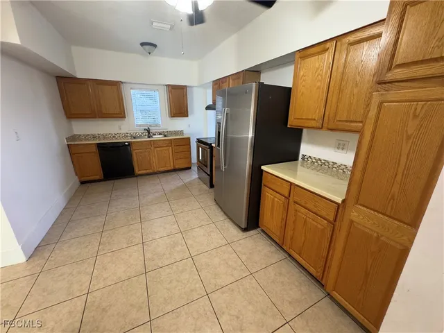 a kitchen with stainless steel appliances a refrigerator sink and microwave