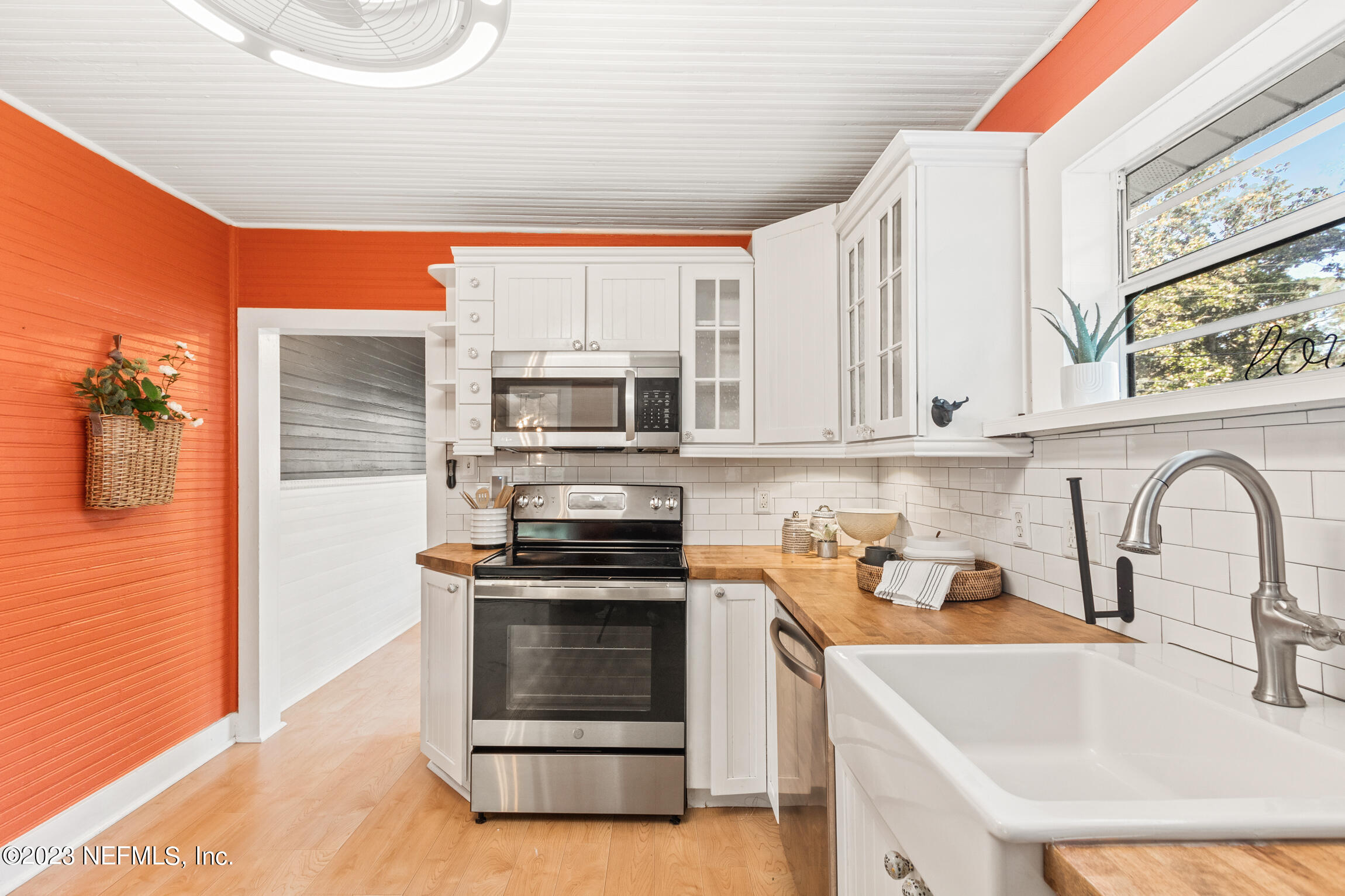 11 Newcomb Street St. Augustine, FL 32084 - Photo 13 of 35 a kitchen with stainless steel appliances a stove a sink and a microwave
