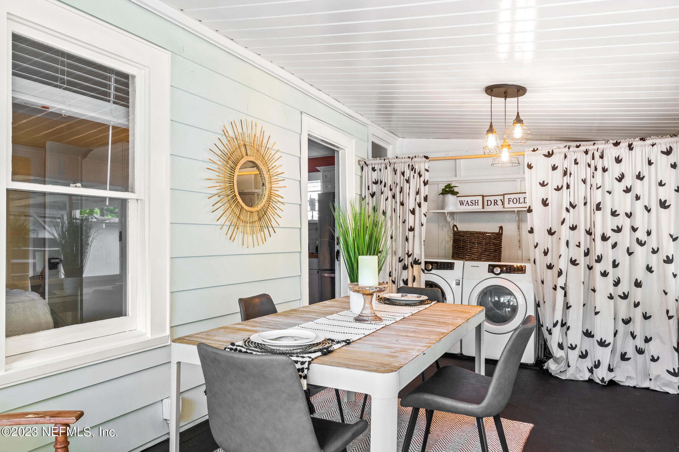 11 Newcomb Street St. Augustine, FL 32084 - Photo 22 of 35 a view of a dining room with furniture a chandelier and wooden floor