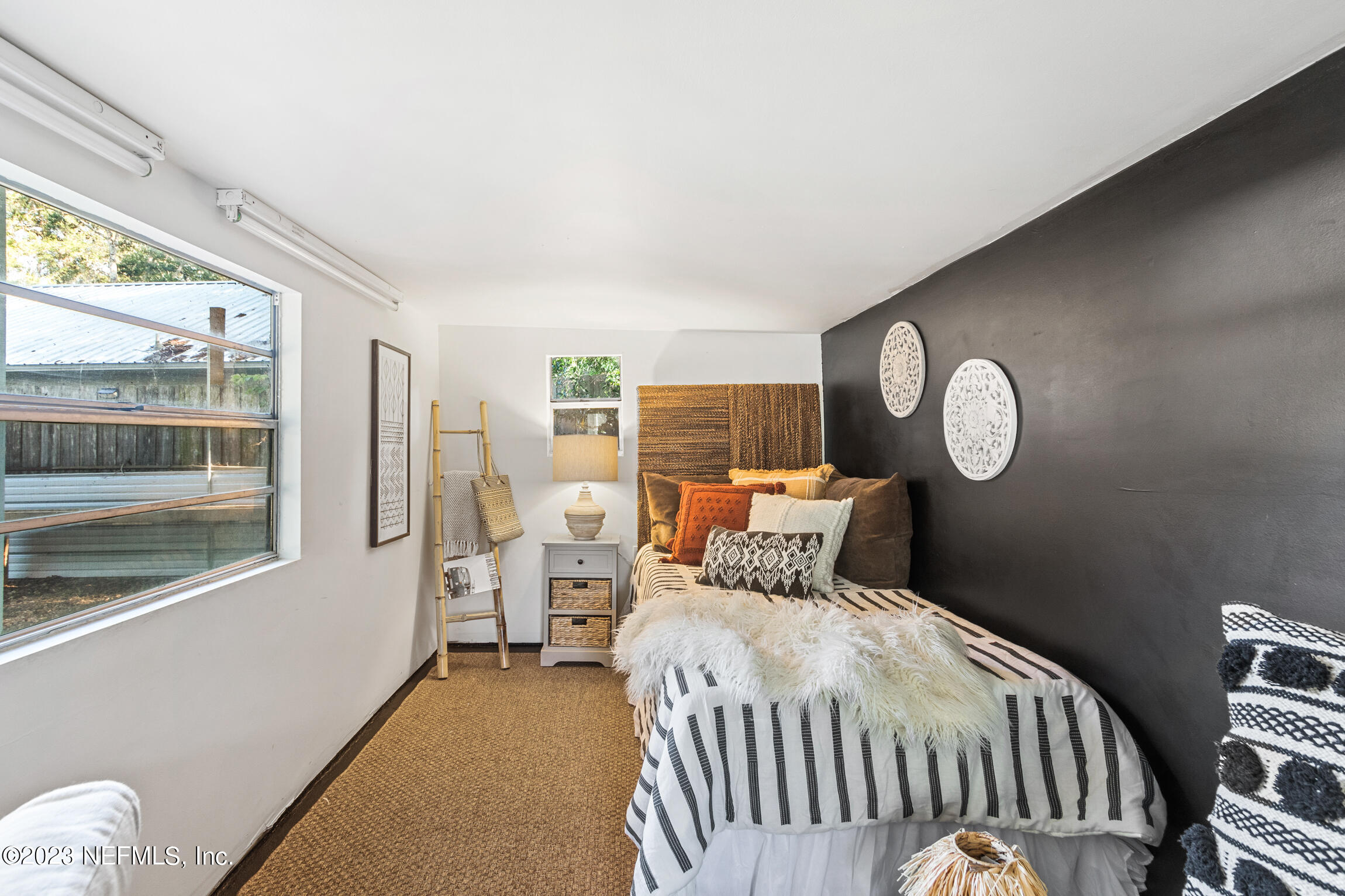 11 Newcomb Street St. Augustine, FL 32084 - Photo 25 of 35 a bedroom with a large bed and a window