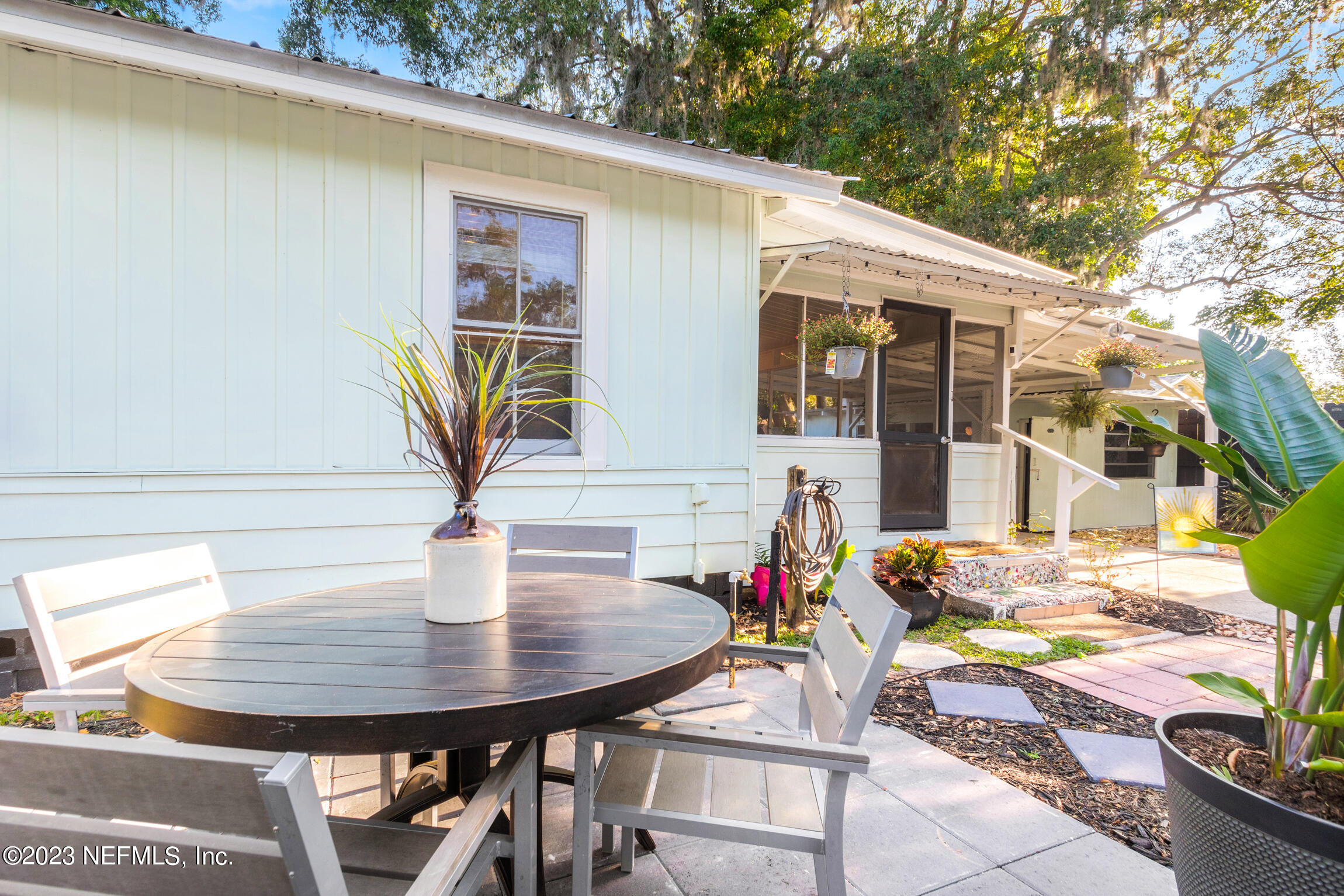 11 Newcomb Street St. Augustine, FL 32084 - Photo 26 of 35 a view of a patio with table and chairs and potted plants