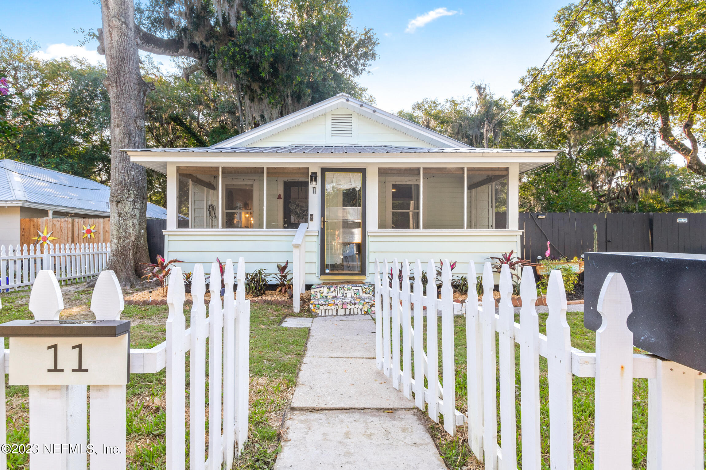 11 Newcomb Street St. Augustine, FL 32084 - Photo 3 of 35 a front view of a house with a garden