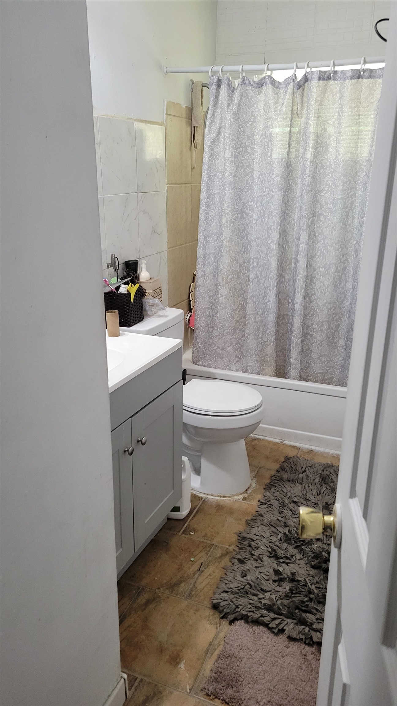 1532 Duke Road Memphis, TN 38108 - Photo 2 of 13 a bathroom with a sink a toilet and shower curtain
