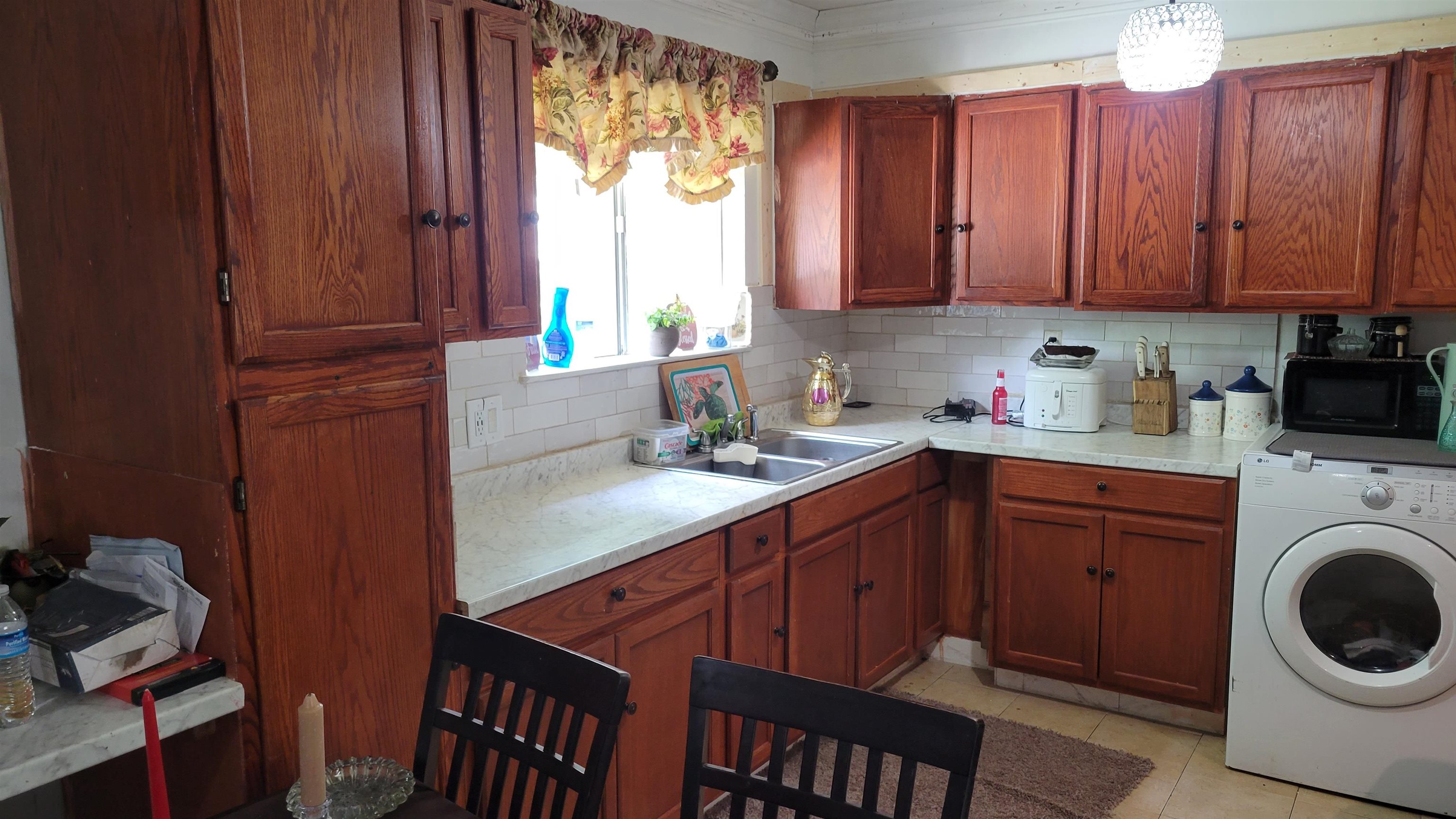 1532 Duke Road Memphis, TN 38108 - Photo 10 of 13 a kitchen with a sink a stove and cabinets