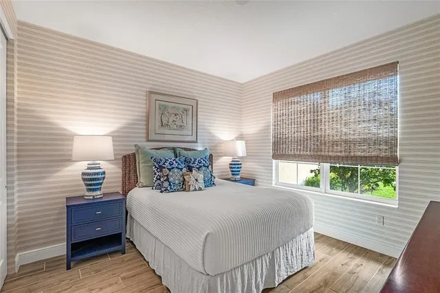 a bedroom with a large bed and a large window