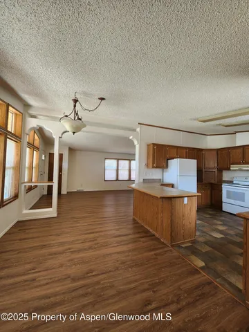 a view of a living room and kitchen view