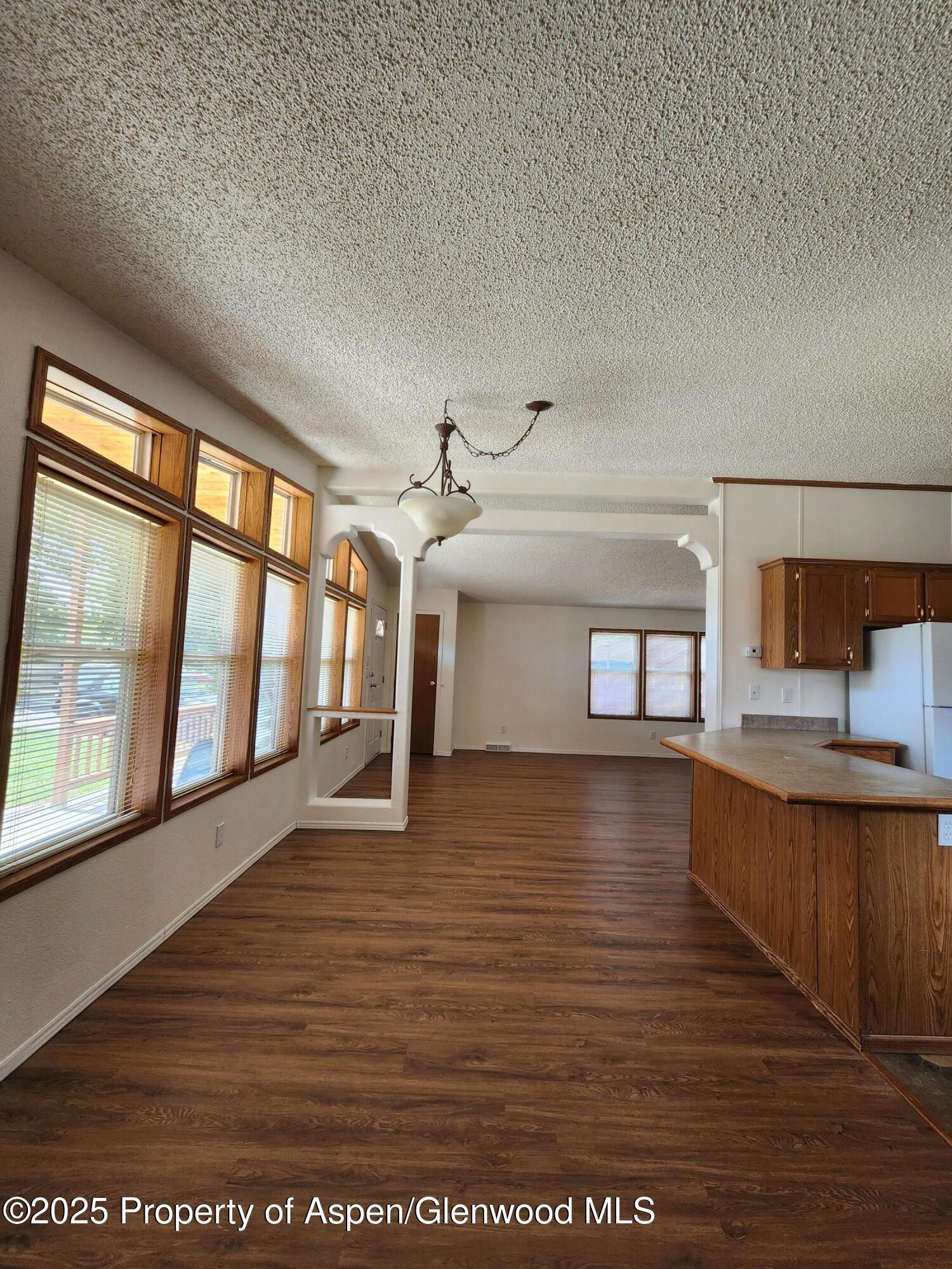 262 East Tamarack Circle Parachute, CO 81635 - Photo 13 of 18 a view of an empty room with window and wooden floor
