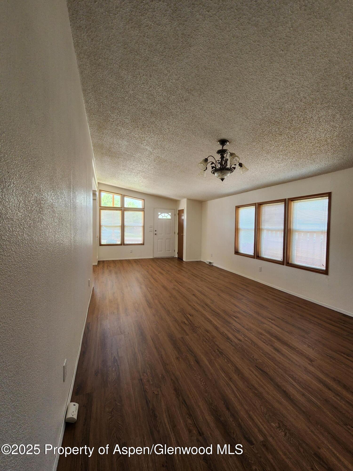 262 East Tamarack Circle Parachute, CO 81635 - Photo 2 of 18 wooden floor in an empty room with a window
