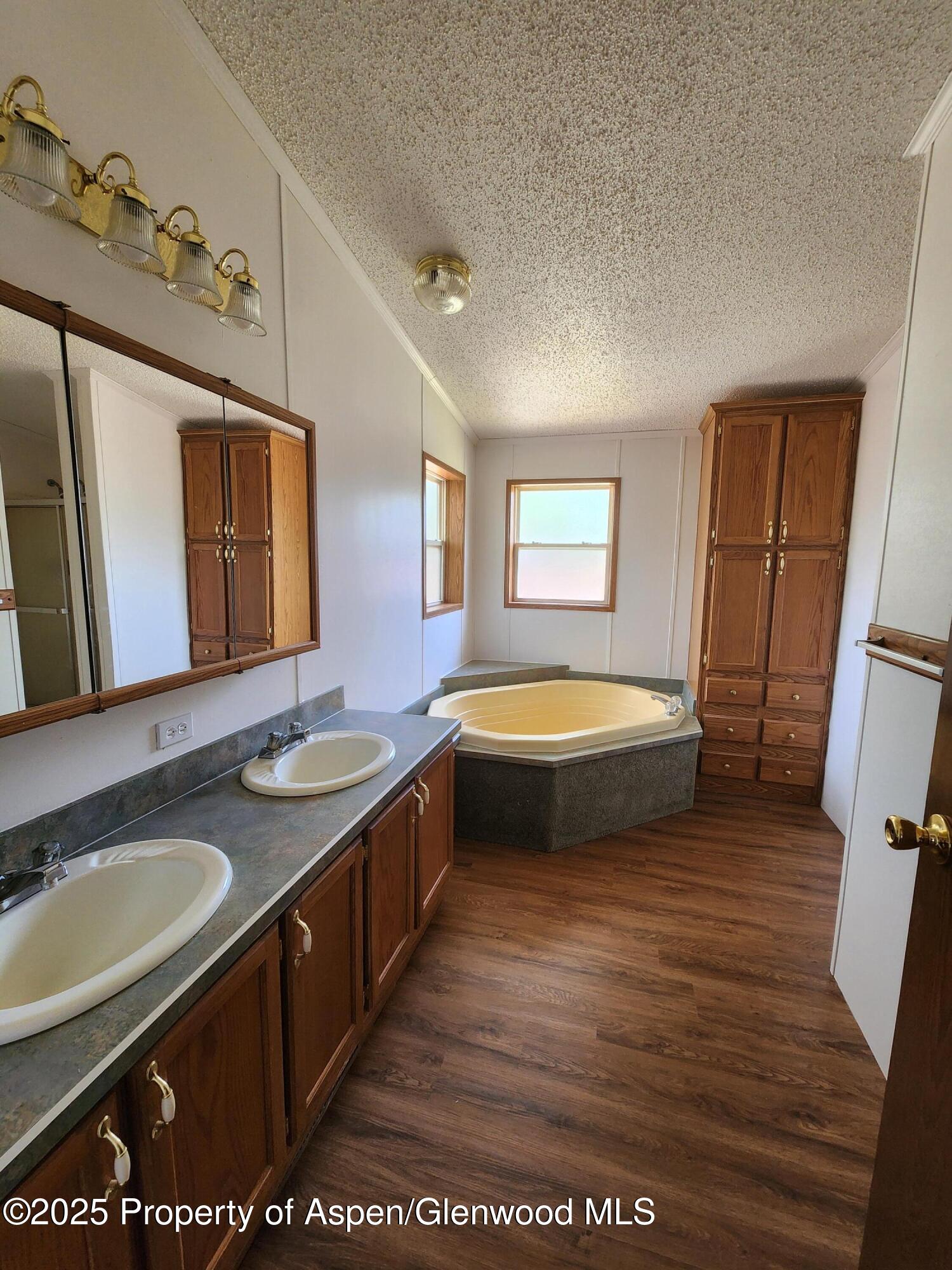 262 East Tamarack Circle Parachute, CO 81635 - Photo 6 of 18 a bathroom with a granite countertop sink a mirror and a bathtub