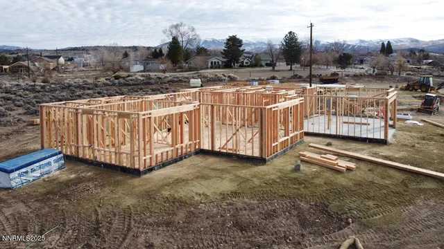 a view of a house with wooden fence