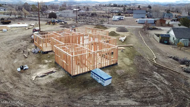 an aerial view of a house with a yard