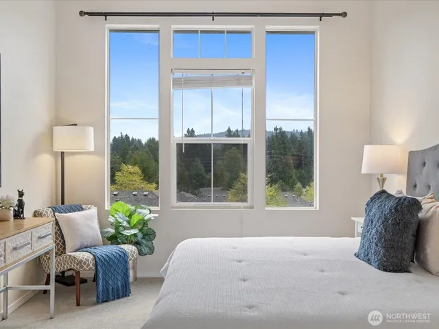 a bedroom with furniture and a large window