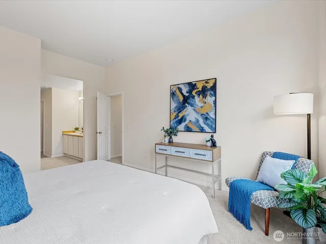 a bedroom with a bed and a painting on the wall