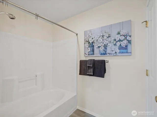 a bathroom with a bathtub and shower