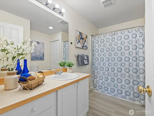 a bathroom with a double vanity sink and a mirror