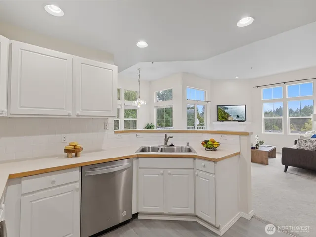 a kitchen with cabinets a sink and a window