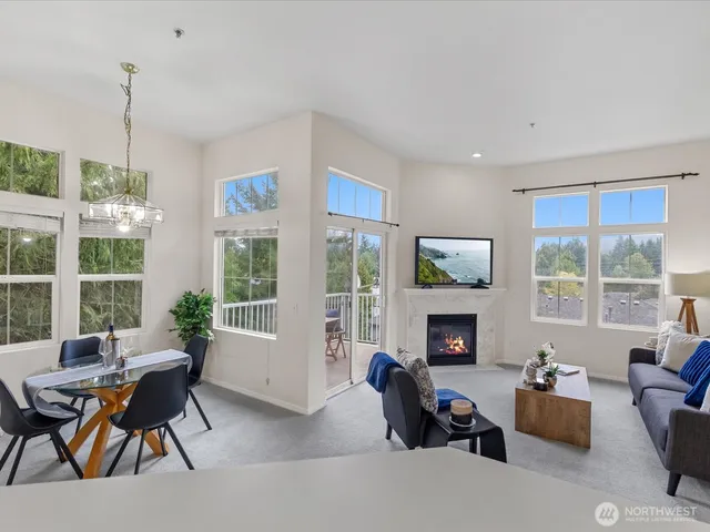 a living room with furniture fireplace and a large window