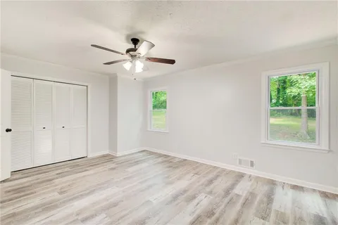 a bathroom with a toilet a sink and a window