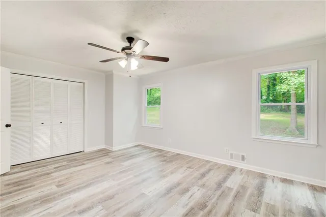 a bathroom with a toilet a sink and a window
