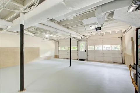 an aerial view of a house with a yard and lake view